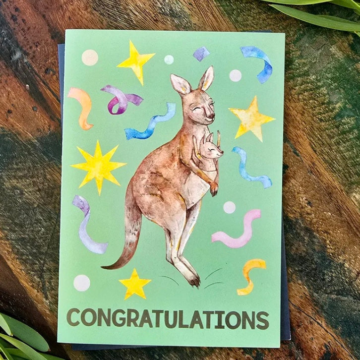 Greeting card with kangaroo illustration and 'Congratulations' text on a wooden surface