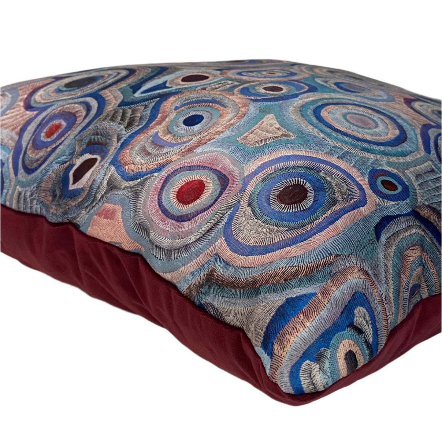 Decorative pillow with a circular pattern on a white surface