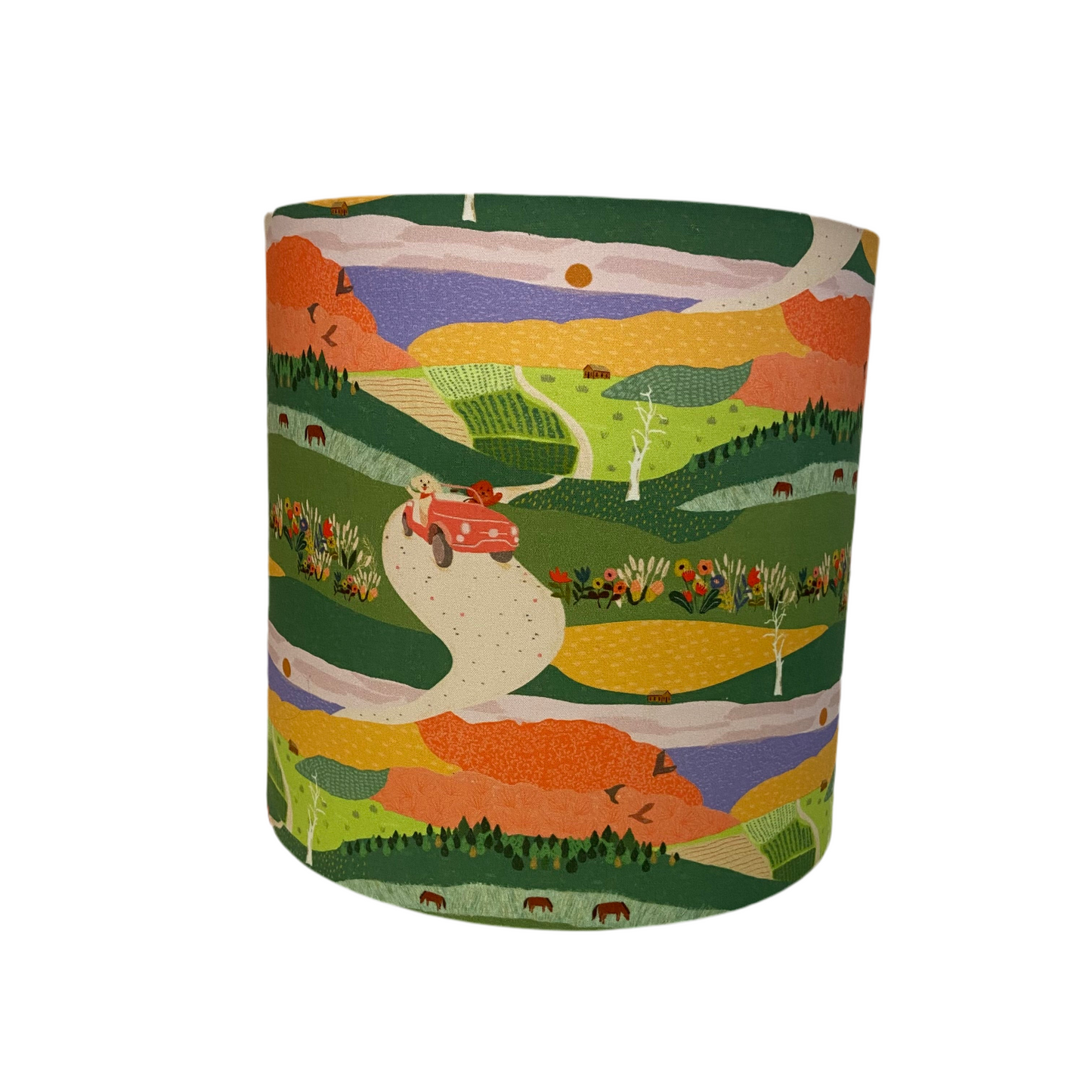 Cylindrica lamp shade with a colorful landscape design on a white background