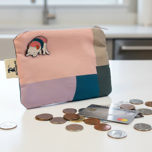 Color-blocked pouch with a cat illustration on a light background