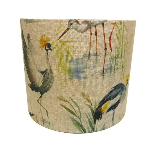 Fabric lampshade with bird design on a plain background