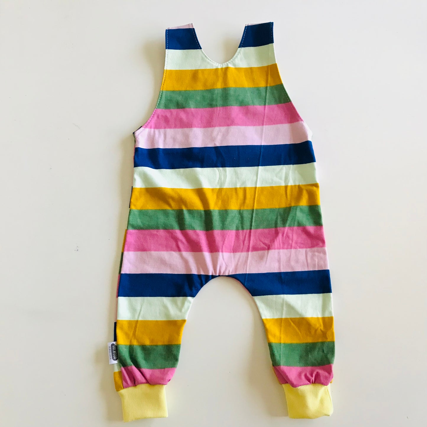 Colorful striped baby romper on a white background