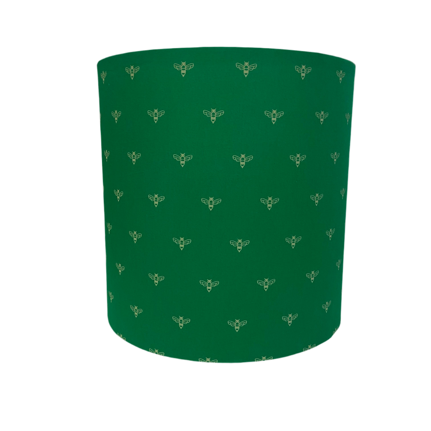 Green cylindrical lamp shade with bee pattern on a white background