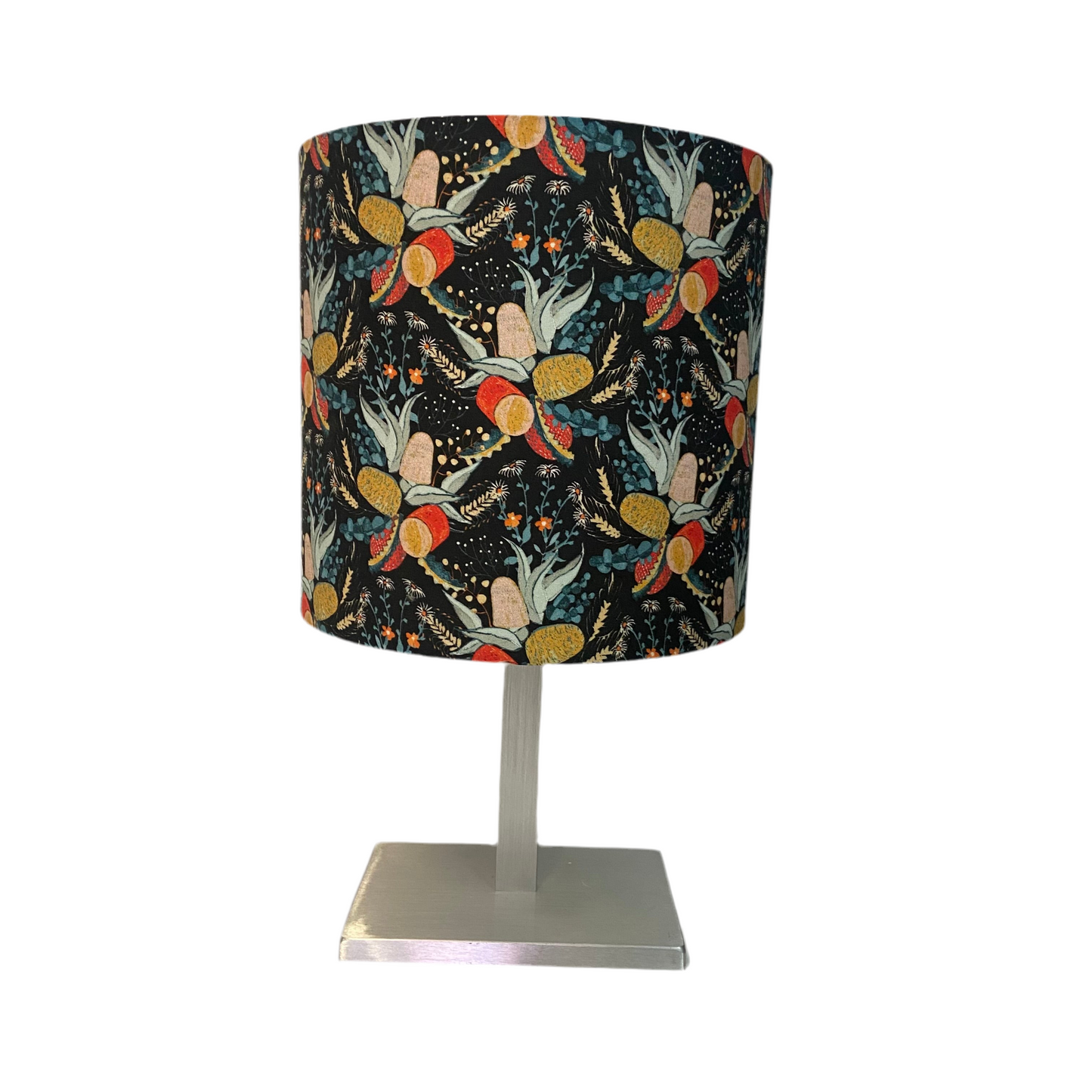 Table lamp with a colorful patterned shade on a white background