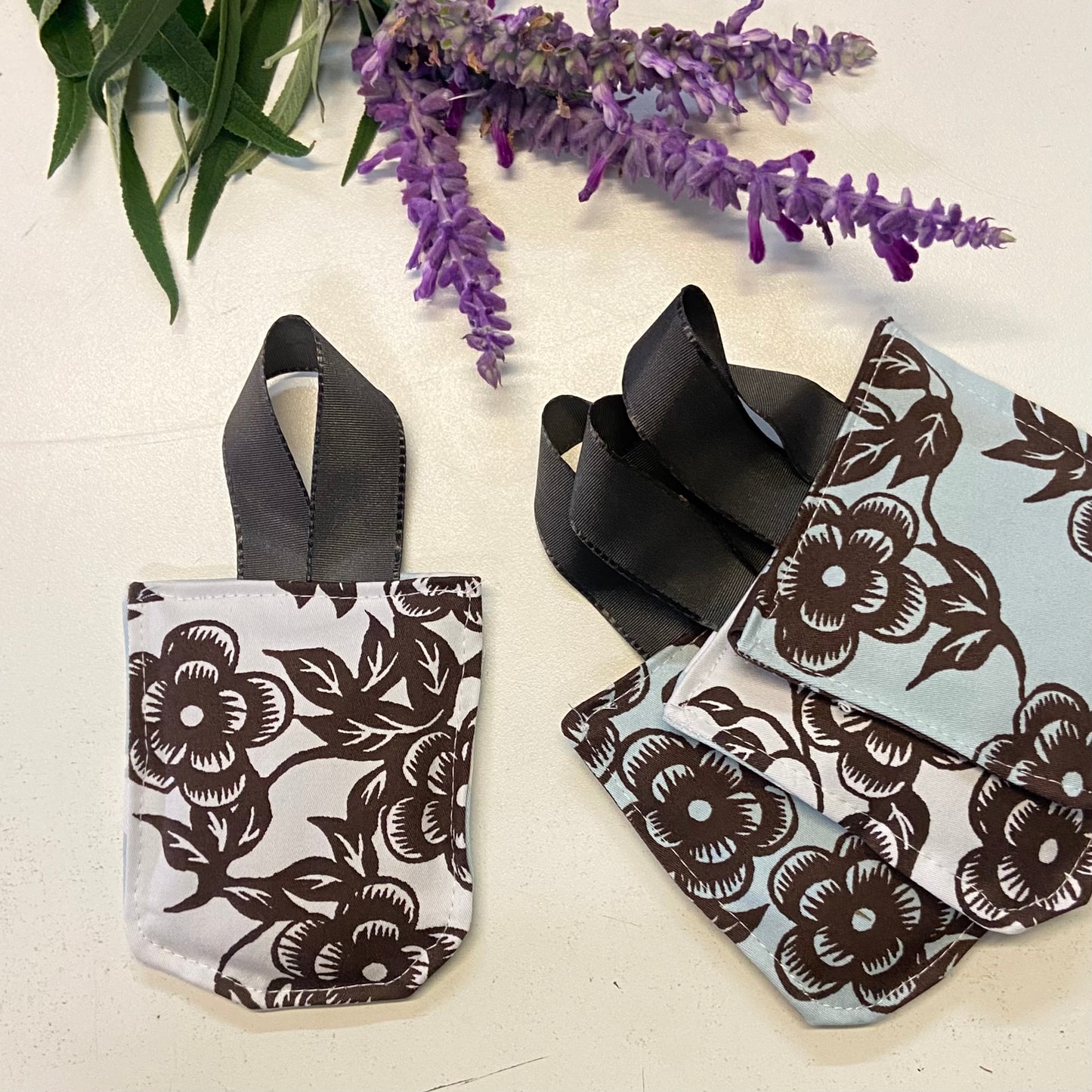 small hanging pouch filled with lavender to hang in your wardrobe or place in your clothing drawers to leave the space gmelling fresh. This set of four pouches have a blue, white & chocolate floral textile.