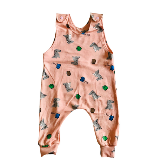 Pink baby romper with animal print on a white background