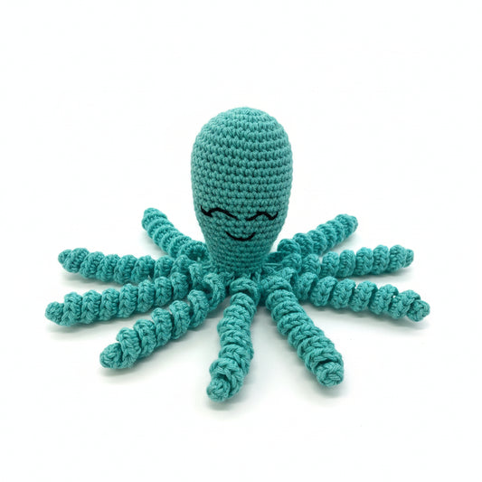 Crocheted teal octopus toy on a wooden surface
