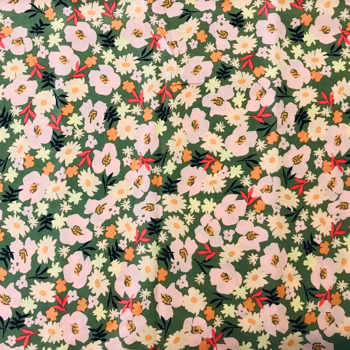 Floral pattern with white and pink flowers on a green background