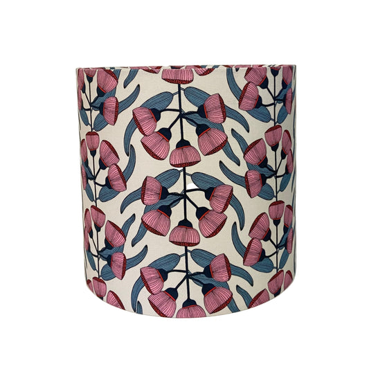 Decorative lampshade with pink and blue floral pattern on a white background