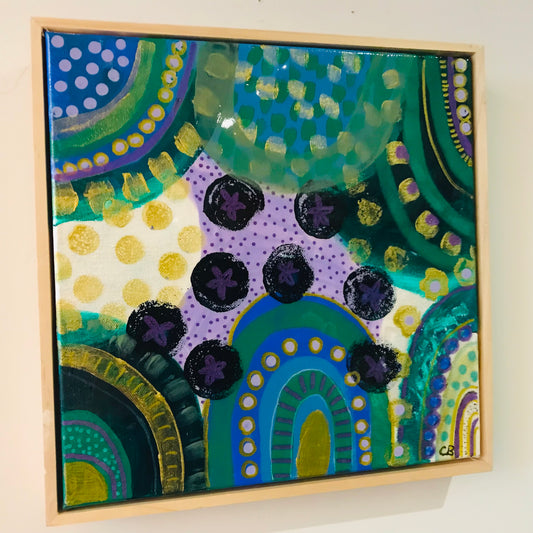 Colorful abstract painting with geometric patterns on a white wall