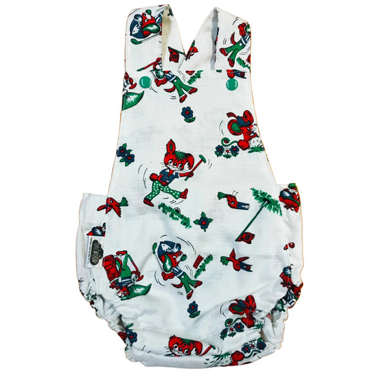 Baby romper with cartoon character print on a wooden surface