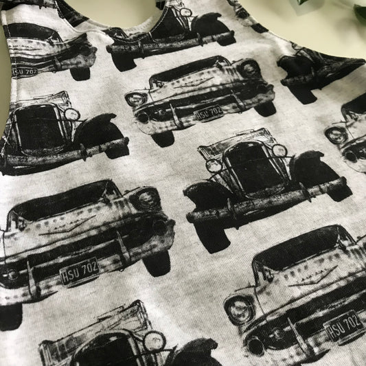 Close up of black and white vintage car fabric used in baby toddler romper overalls