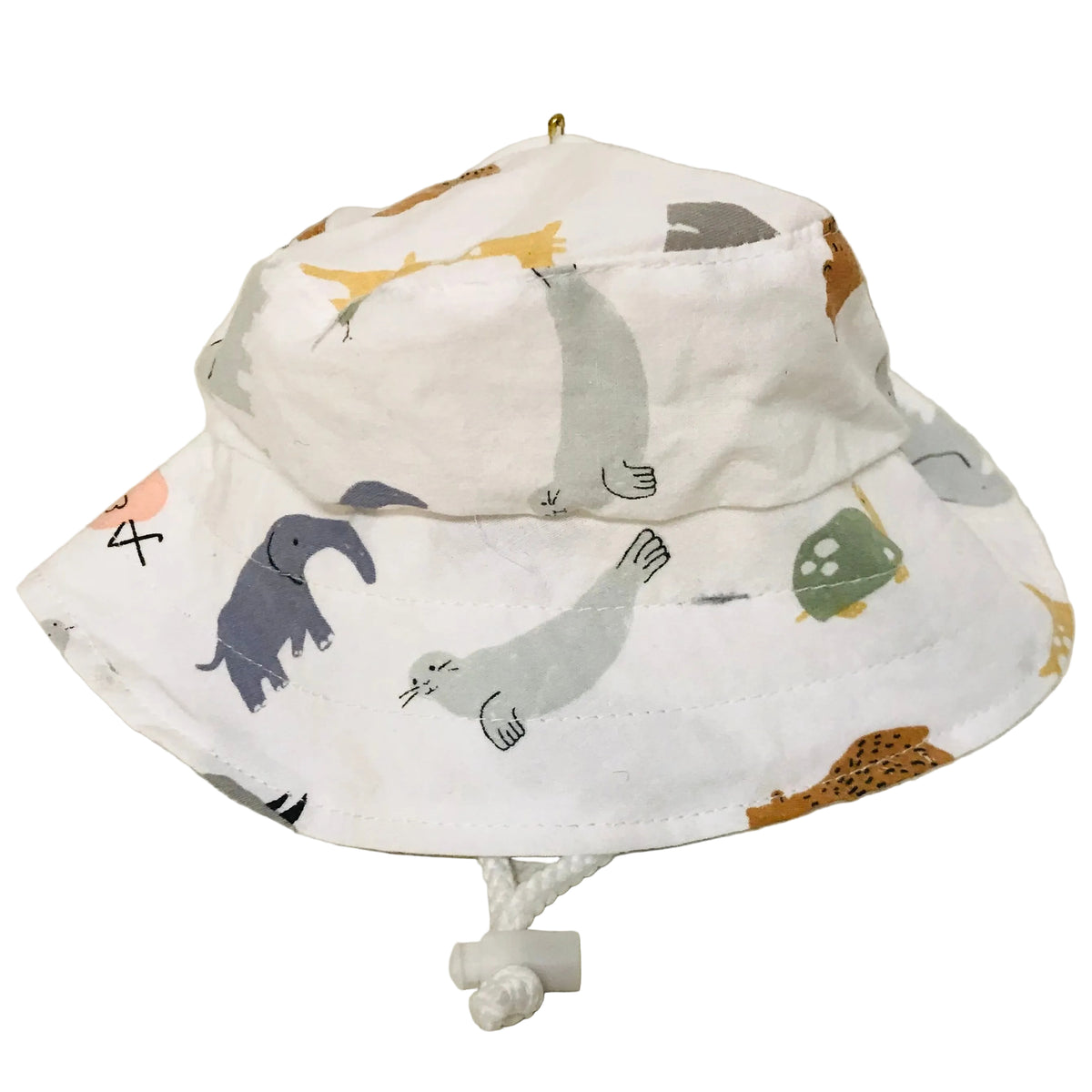 A white fabric sun hat with an all-over animal print featuring seals, a blue elephant, a green turtle, and orange birds, resting on a light-colored floor.