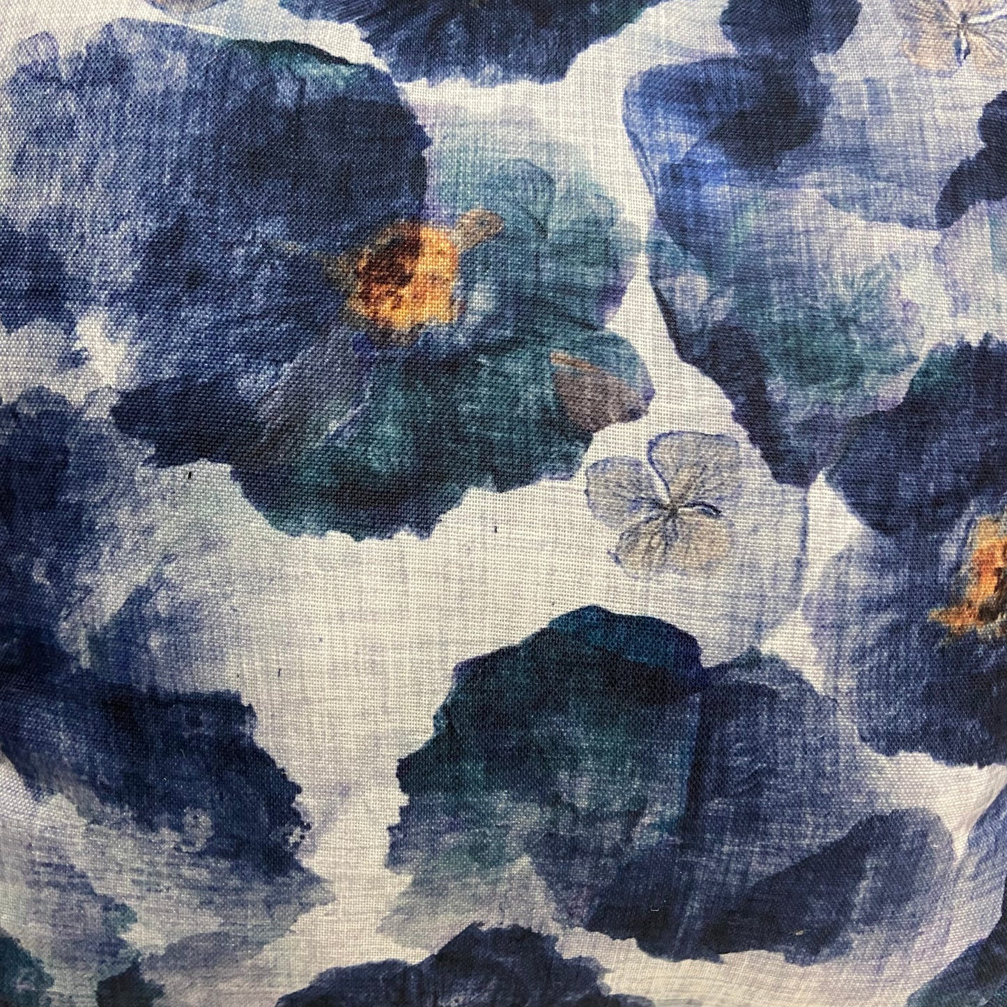 Close-up of floral fabric pattern with blue and green flowers on a textured background