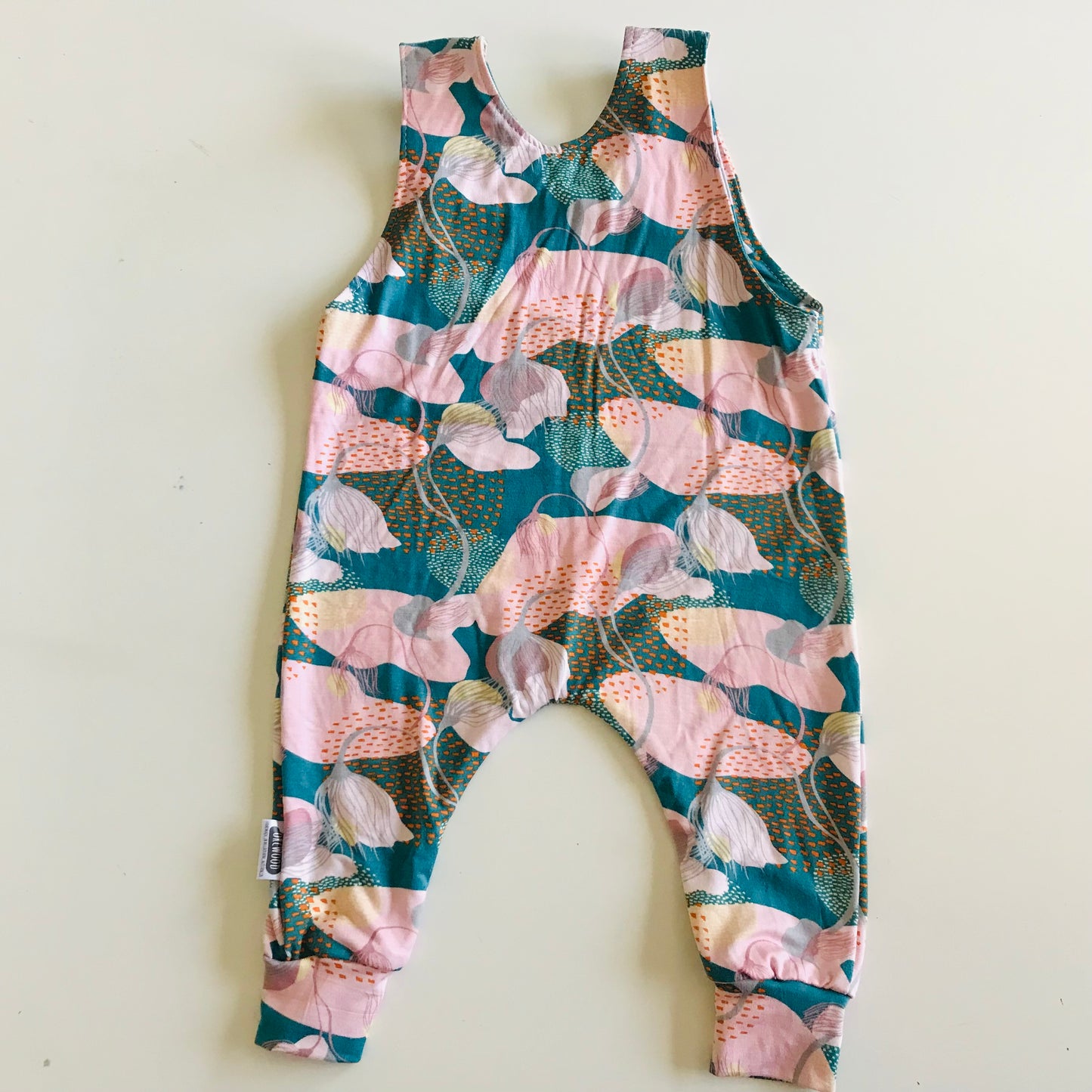 Floral-patterned sleeveless jumpsuit on a white background