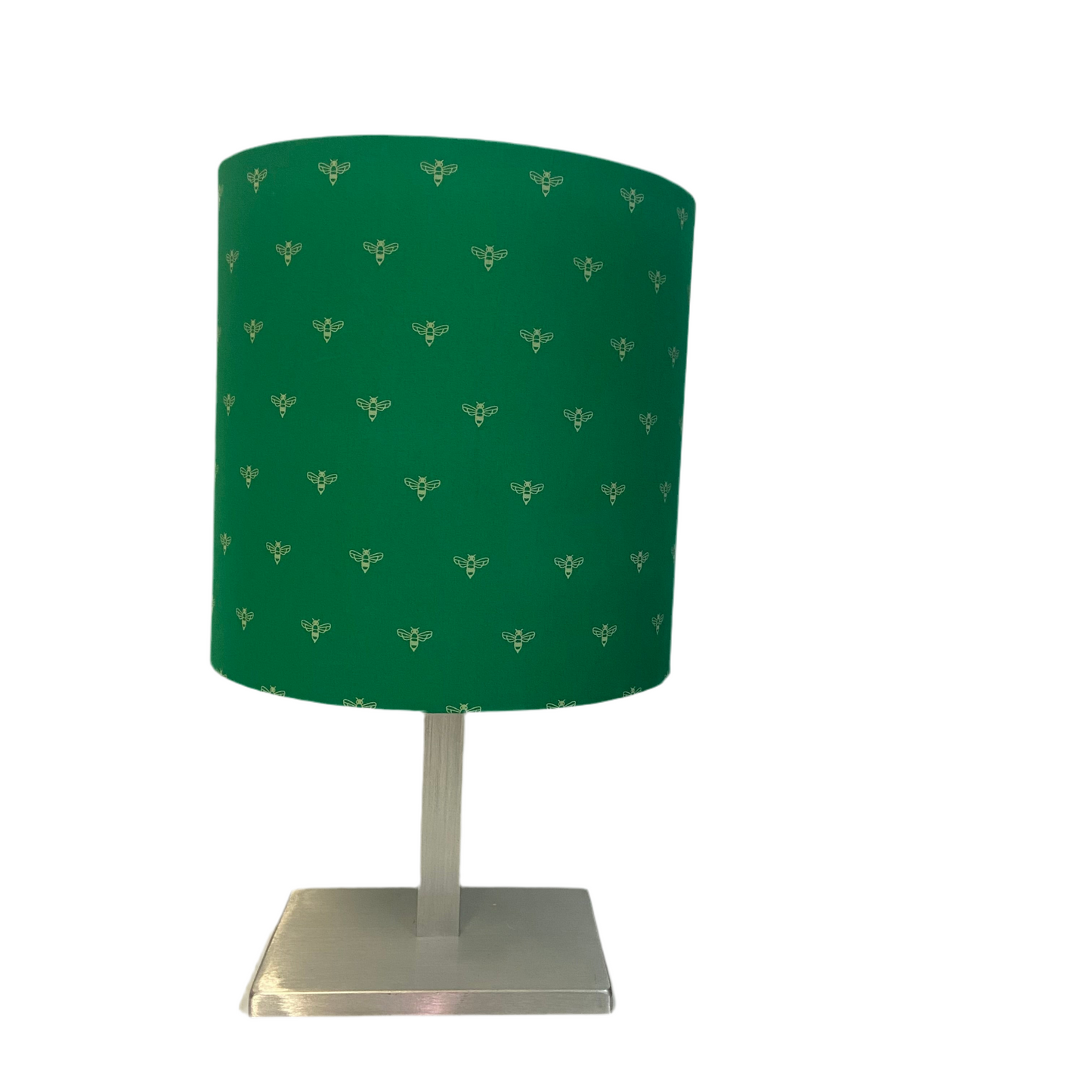Green lampshade with a bee pattern on a white background
