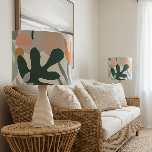 Living room with wicker sofa, abstract art, and decorative lamps.