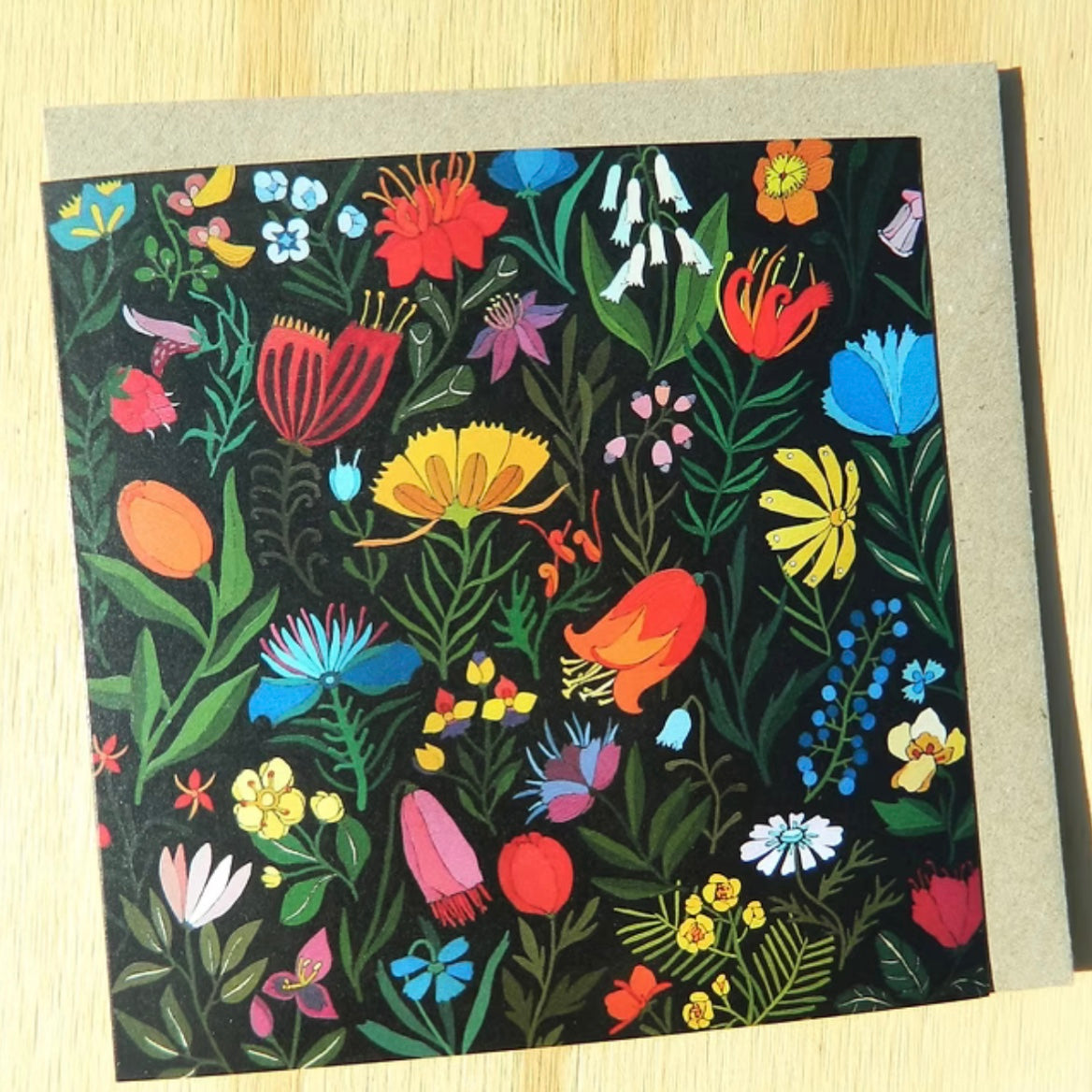 greeting card featuring a Colorful floral pattern on a black background with a gray border