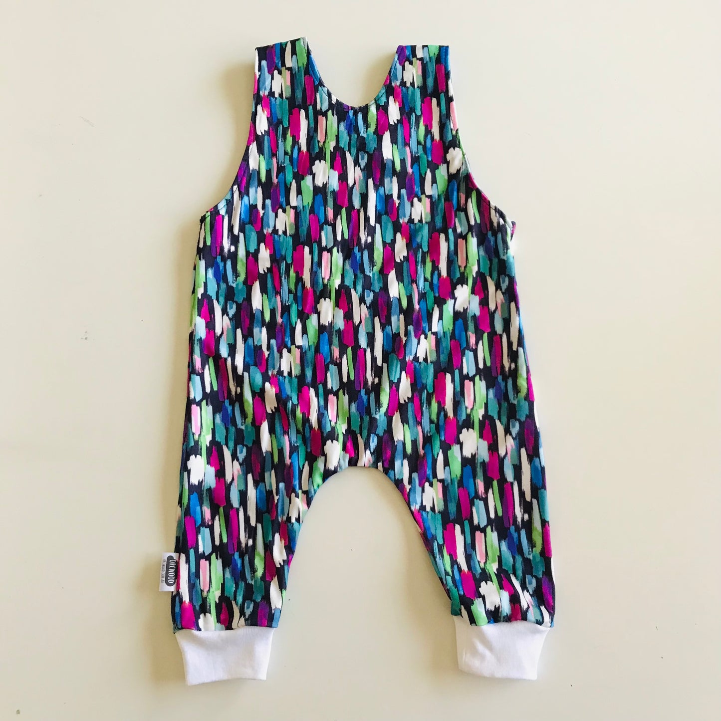 Colorful patterned romper on a light beige background