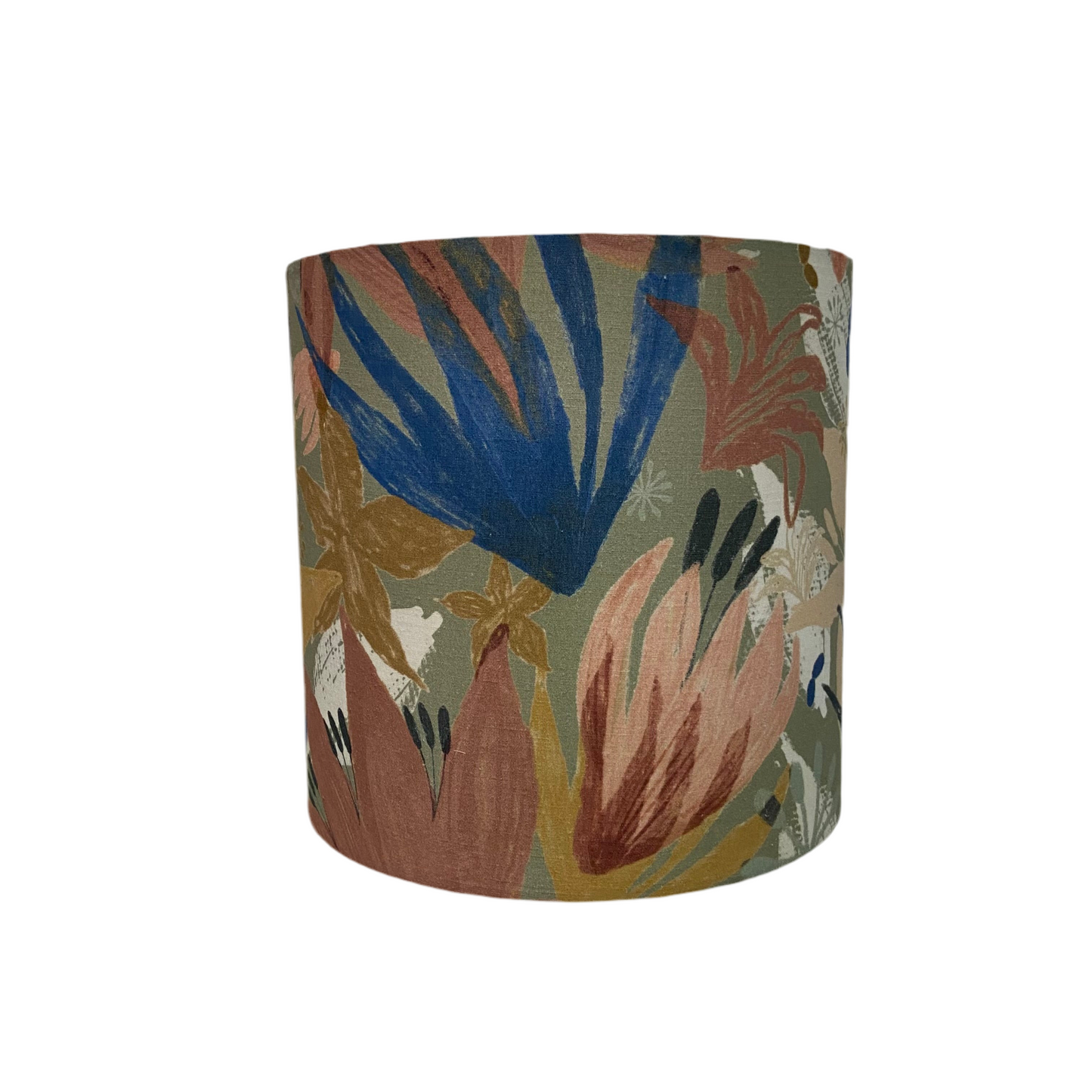 Cylindrical fabric lampshade with a muted floral pattern in eqrthy tones on a white background