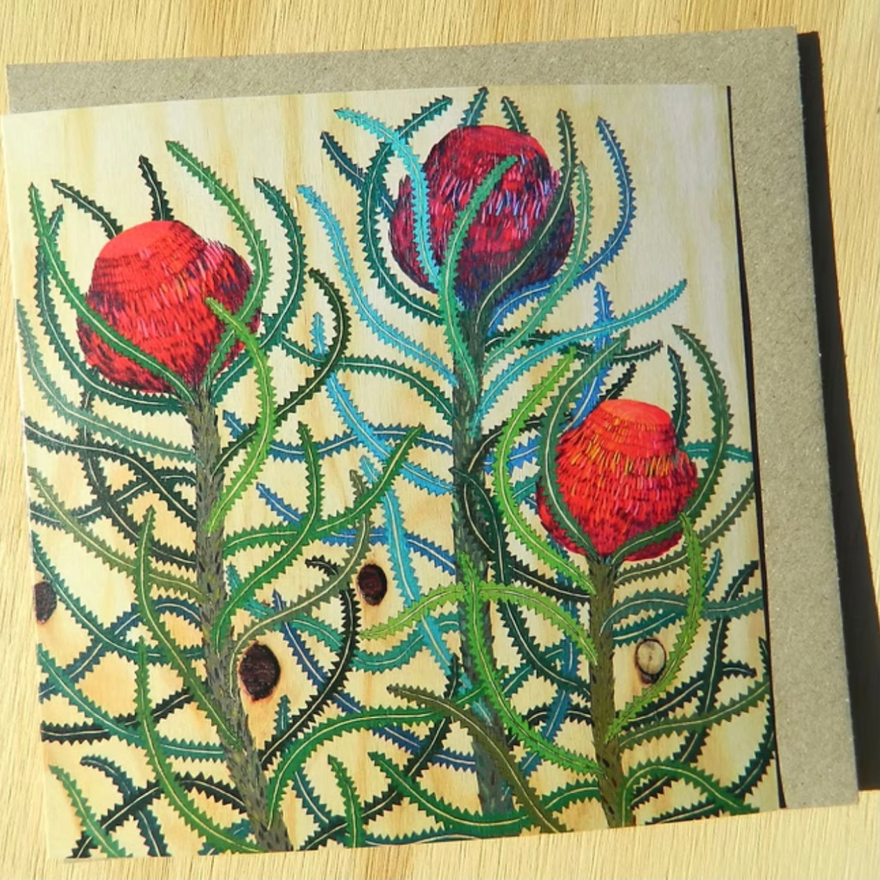 Greeting card with floral design on a wooden surface