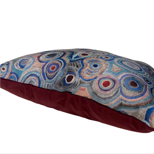 Decorative pillow with circular pattern on a plain background