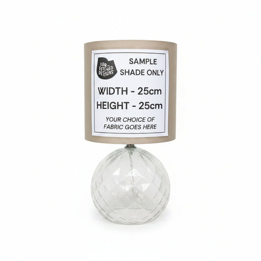 Lampshade with a label indicating sample dimensions and fabric choice on a white background