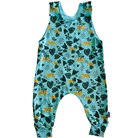 Children's handmade long romper
overalls with a floral and animal pattern on a light blue background