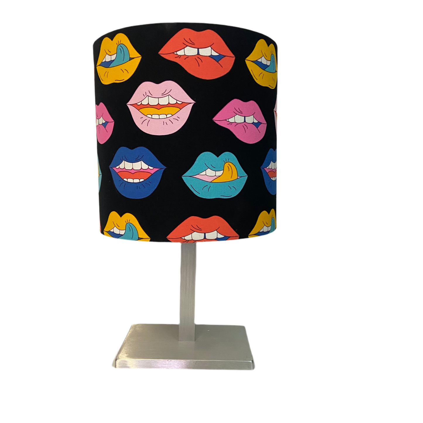Table lamp with colorful lips patterned shade on a white background