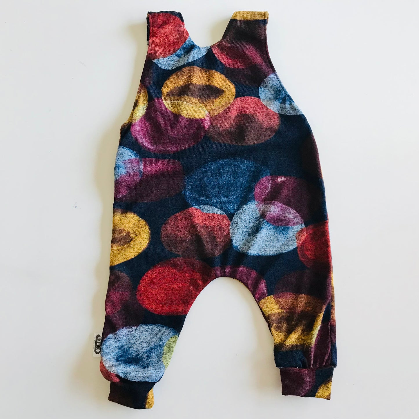 Colorful patterned baby romper on a white background