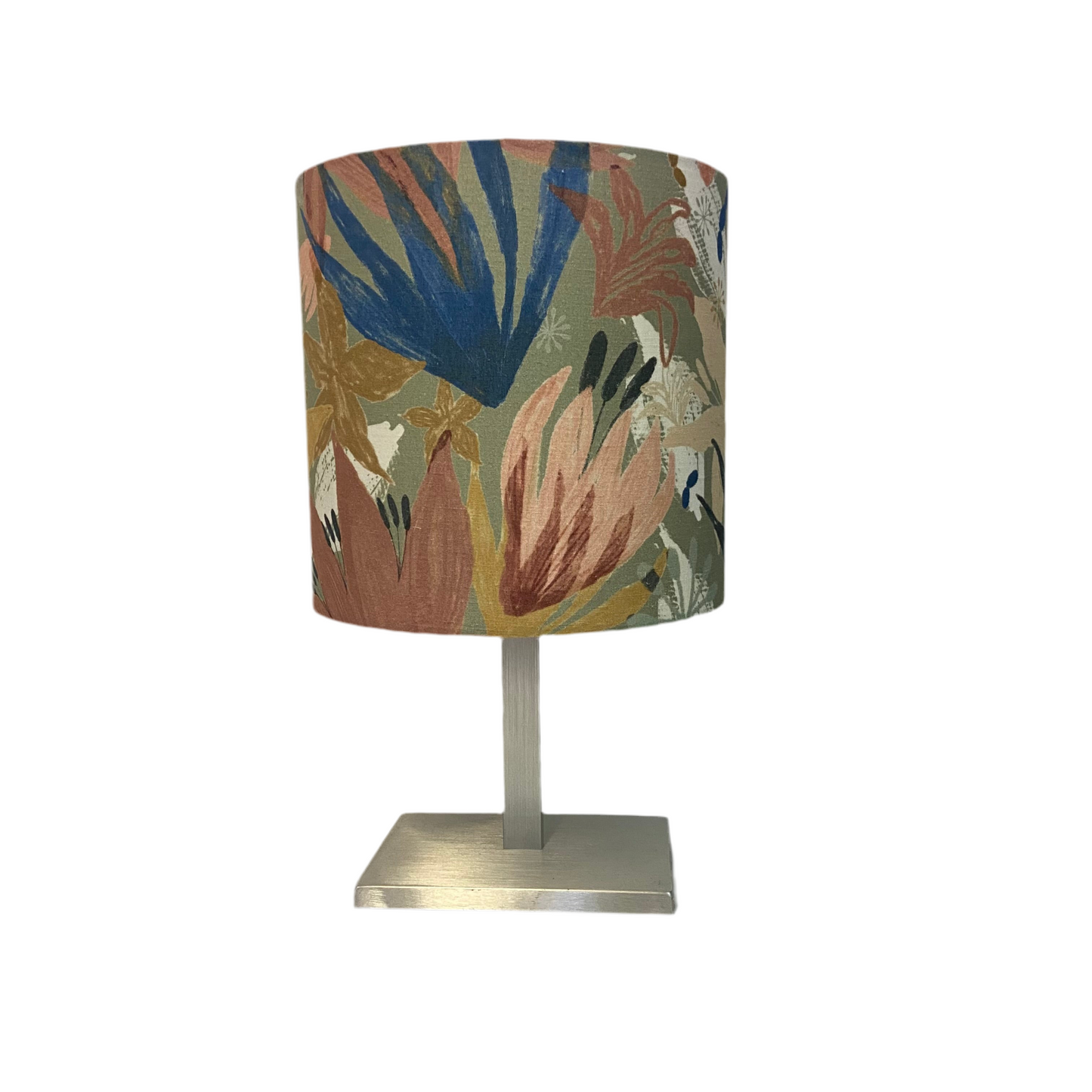 Table lamp with a muted floral-patterned shade on a white background