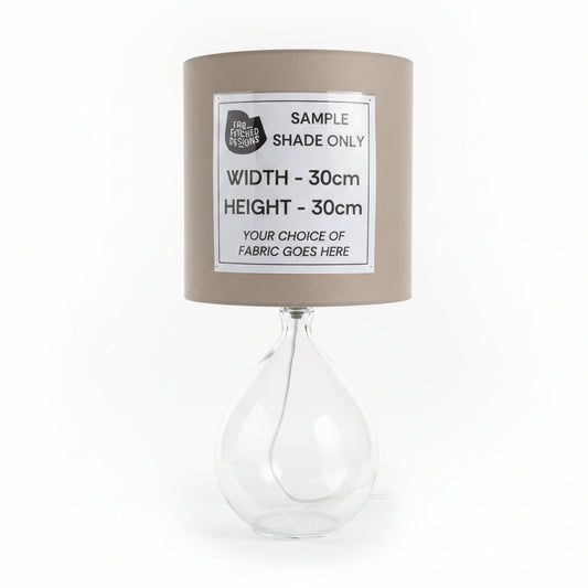 Lamp with a sample shade and text label on a white surface.
