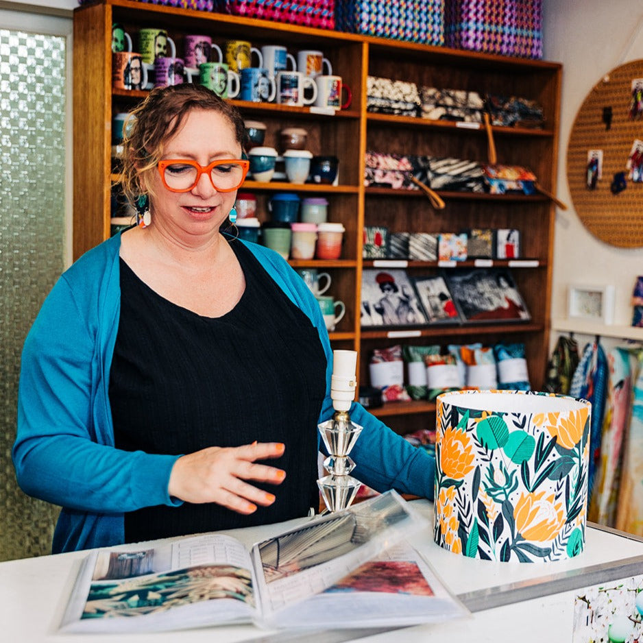 Co-owner Rachael from Orcwood displaying options for custom lamp shades in store at Far Fetched Designs