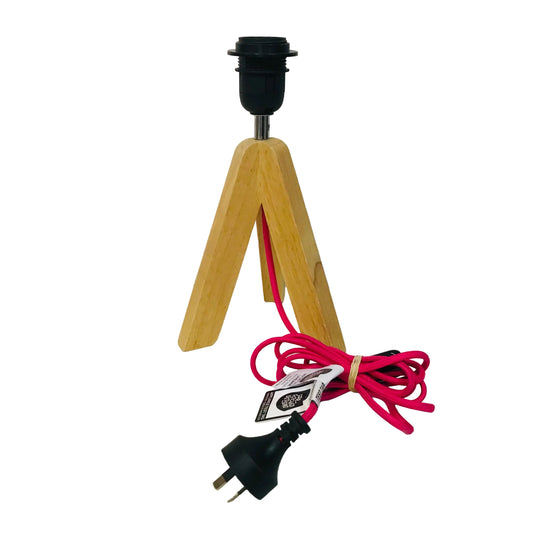 Wooden lamp base with a pink cord and black plug on a white background