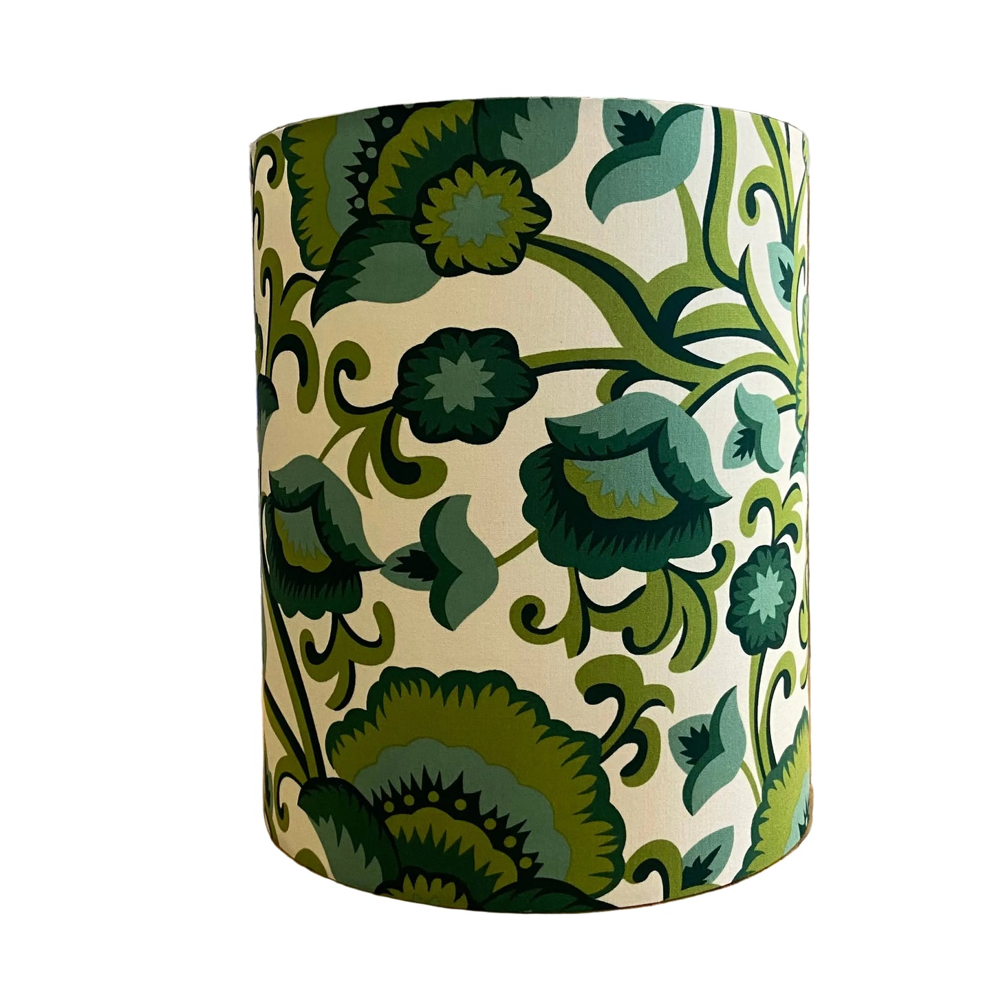 A cylindrical lampshade featuring a classic botanical pattern with green leaves and vines on a warm cream background.