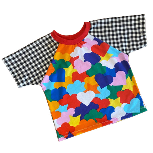 Colorful t-shirt with heart and cloud shape pattern on a white background