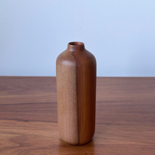 Wooden handle on a wooden door with a light blue background
