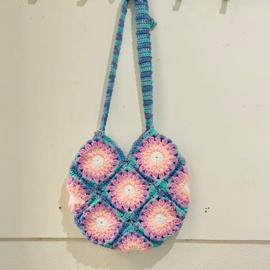 handmade crochet granny square shoulder bags with adjustable straps in blues and pinks