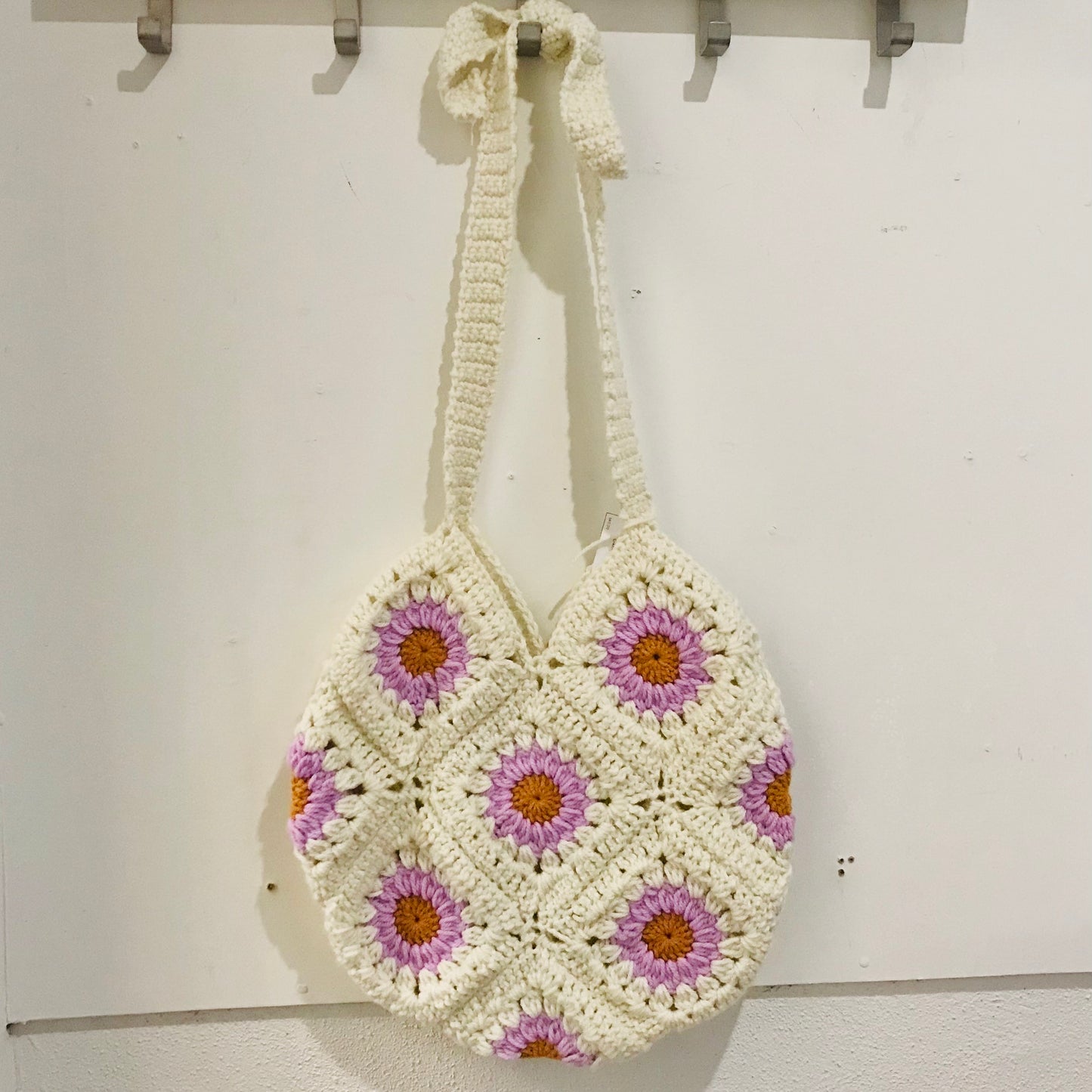 handmade crochet granny square shoulder bags with adjustable straps in white with purple