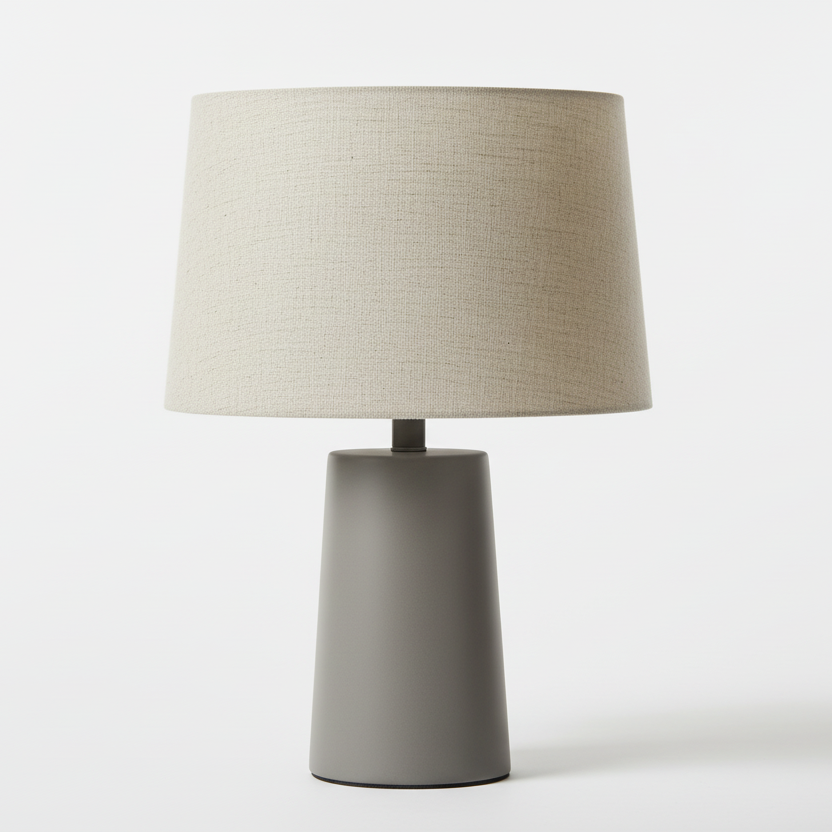Table lamp with a beige shade and gray base on a white background