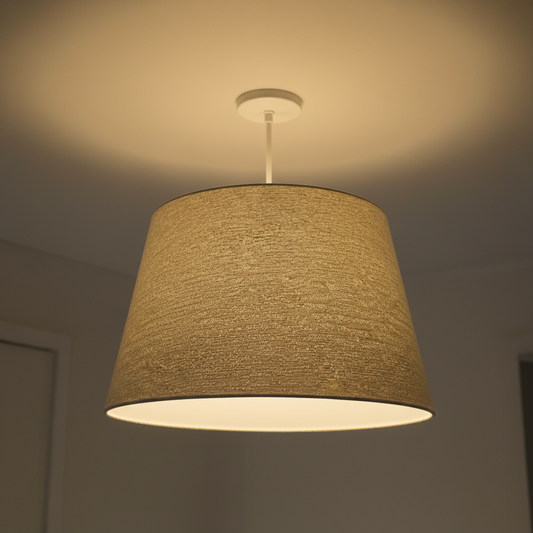 Textured pendant light hanging from the ceiling in a dimly lit room.