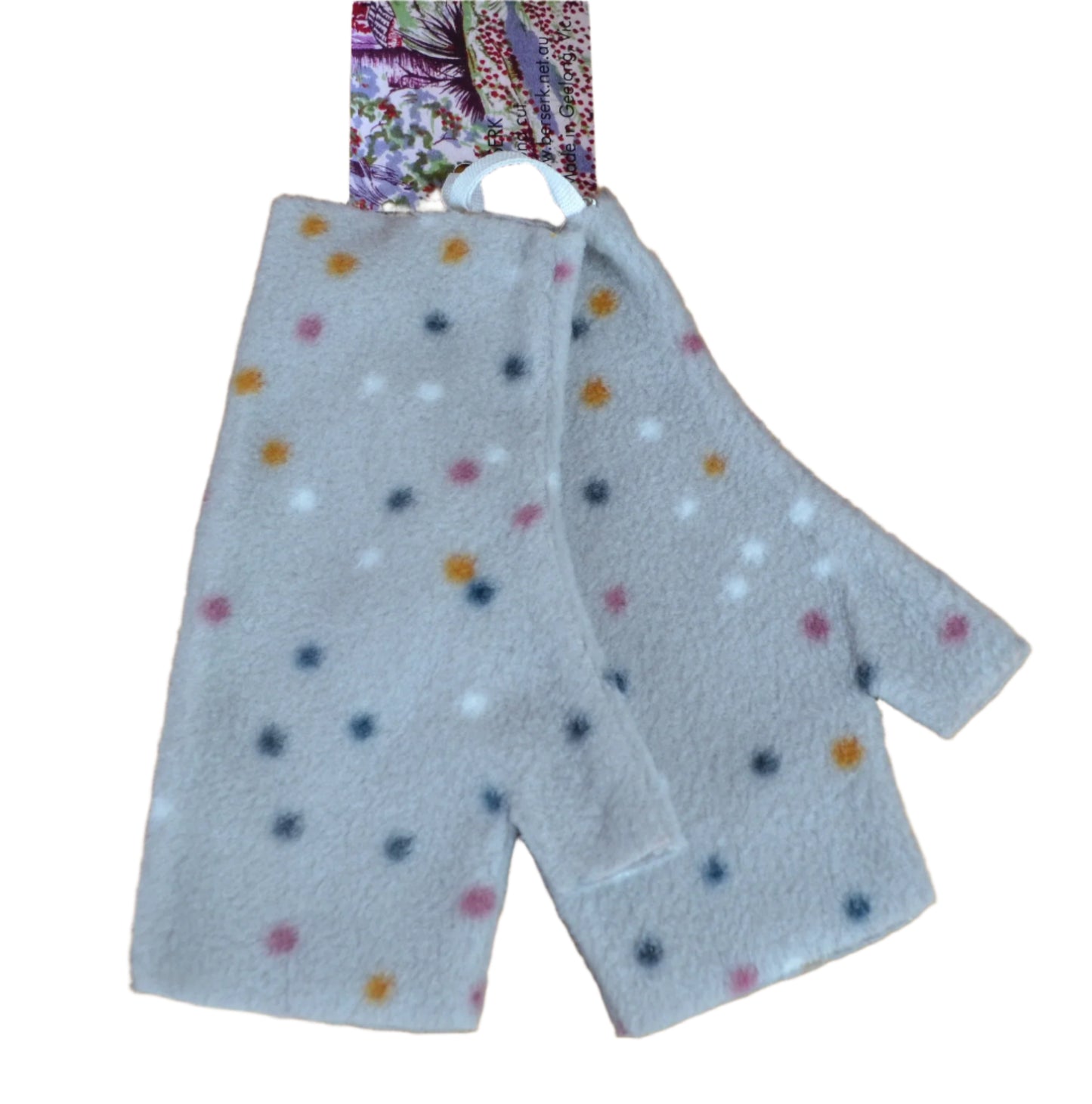 Pair of gray gloves with colorful polka dots on a wooden surface