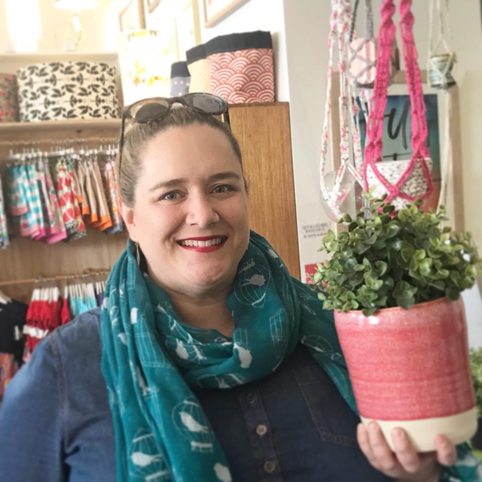 Nicole from Acacia Ceramics holding a planter she made