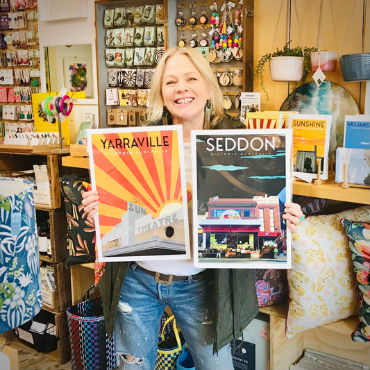 ARTIST KERRIE GOTTLIESBRN HOLDING TWO OF HER PRINTS IN FAR FETCHED DESIGNS