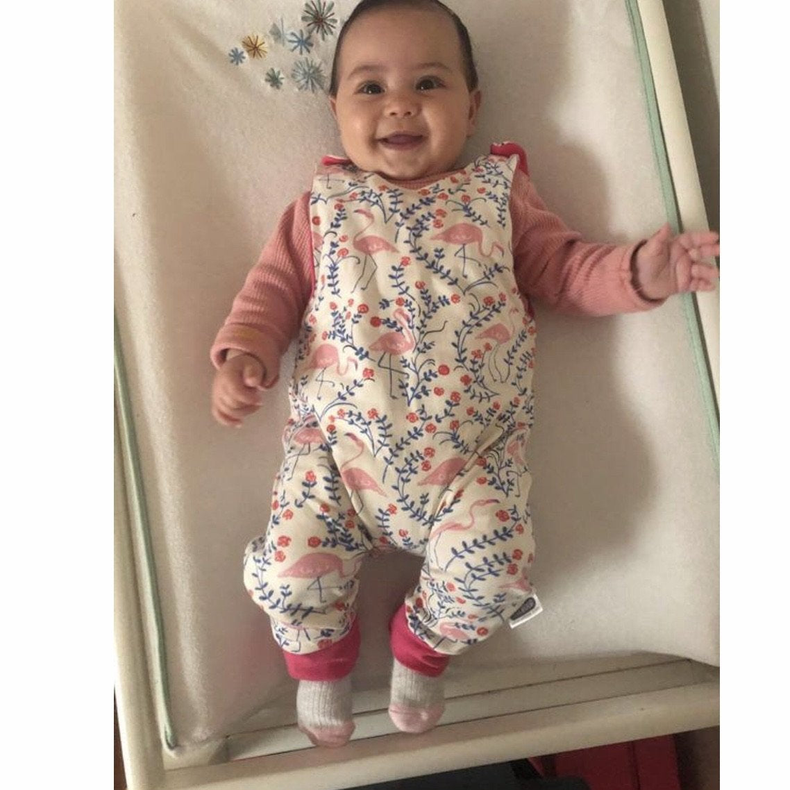 Baby wearing the handmade long romper overalls