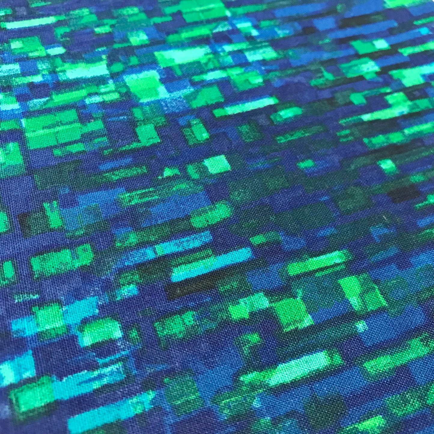 Patterned fabric with blue and green geometric design