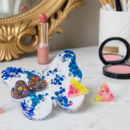 Colorful resin jewelry pieces on a dressing table