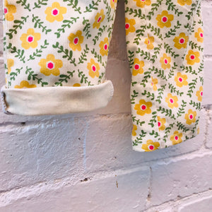 kids overalls with tie shoulders and yellow flower print, made of pinwale cord
