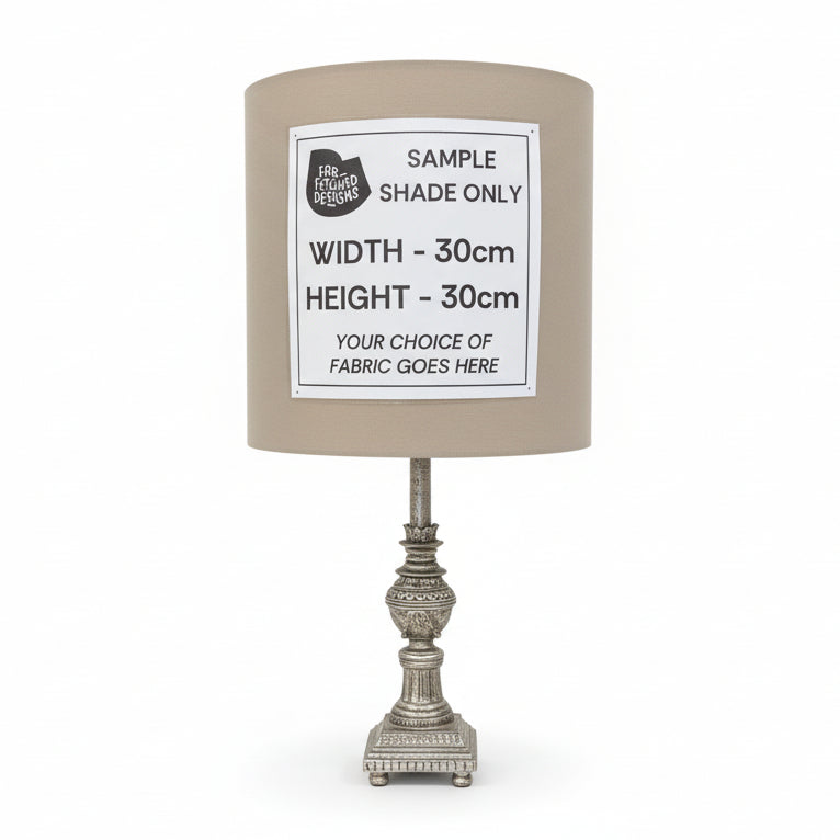 Lampshade with a label indicating sample size and fabric choice options on a white surface.