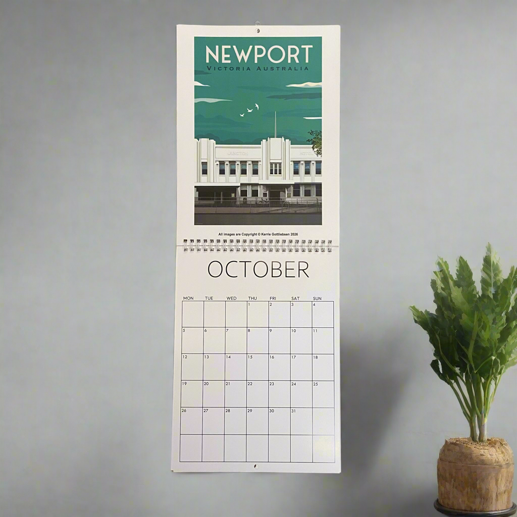Calendar with a scenic view of Newport, Victoria, Australia on a gray wall with a plant.